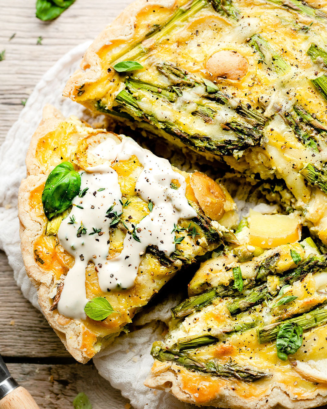 https://soomfoods.com/cdn/shop/articles/20220404214737-spring-veggie-quiche-with-lemon-herb-tahini-social-1_1600x.jpg?v=1649343610